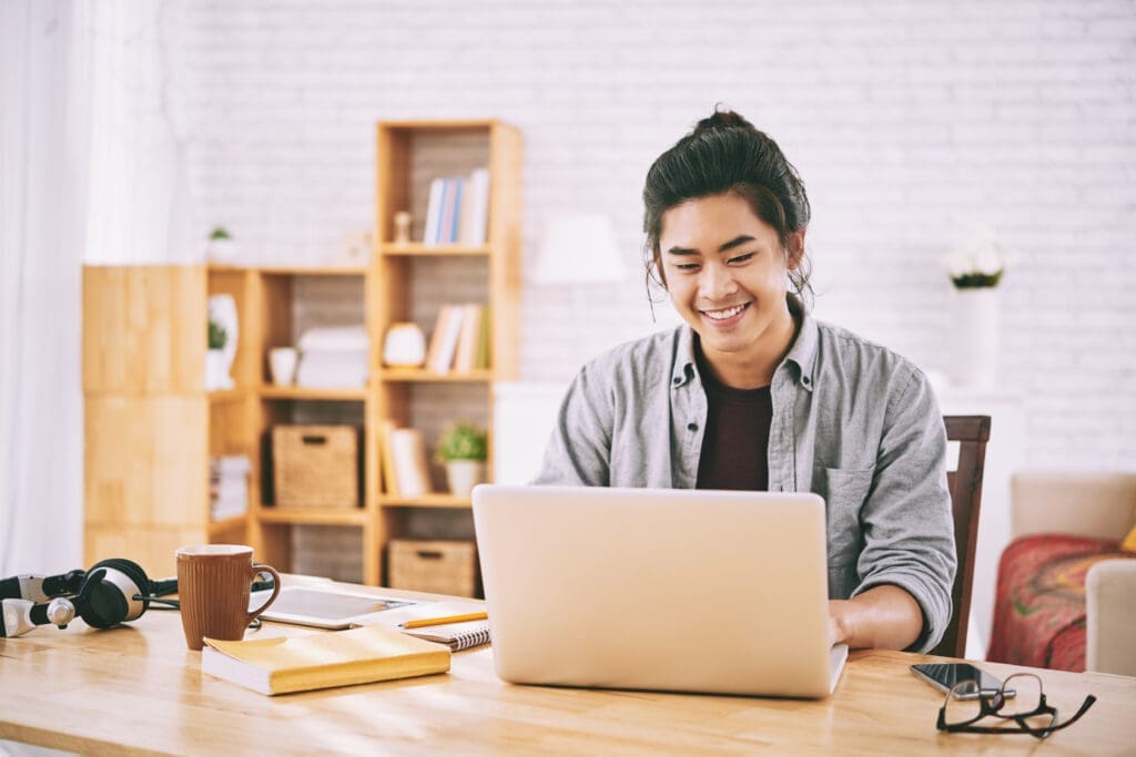Young Man Using Laptop Computer to Safely and Conveniently For Online Notary Digital Signing
