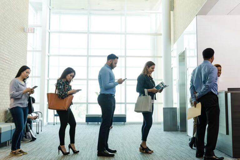 People Waiting In Line at Bank For A Notary Public To Sign